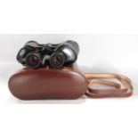 A pair of barely used Carl Zeiss Jena 8x50B Octarem binoculars in a brown leather case. (Lacks one