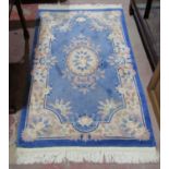 Three Chinese washed wool rugs in cream, blue and steel grey back grounds, all with floral