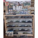 Collection of 20 model military tanks in perspex boxes, in a wooden wall mounted display unit