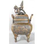 A Chinese bronze koro and cover with a mystical beast, stamped to the base, 22cm high.