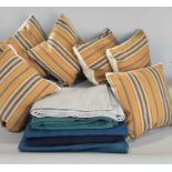 6 cushions in striped ticking fabric together with heavyweight cotton cloths dyed in various shades