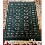 An unusual green Turkoman rug with a central panel of elephant foot gul, 110cm x 80cm approx.