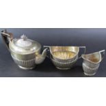 A silver three piece tea service, London 1897, makers mark rubbed, 26 ozs all in