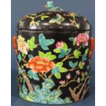 A Chinese famille verte bowl and cover with peony and prunus blossom detail, 22cm high