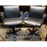 A pair of good quality swivel and height adjustable chair back stools with chrome and cast alloy