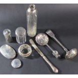 A mixed selection of silver including a tea strainer, pepper pot, glass bottles with silver lids/