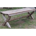 A weathered teak garden table of square cut form with slatted panelled top, 90 cm square x 75 cm