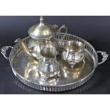 An early 19th century silver plated tray with a three piece tea service, and two silver plated