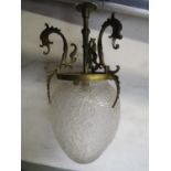 A early 20th century hanging ceiling light with frosted egg shaped glass shade, supported by a