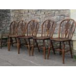 A set of five Windsor stained elm and beechwood hoop and stickback dining chairs with central