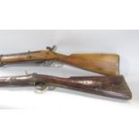 An 18th century flintlock musket and a 19th century percussion rifle