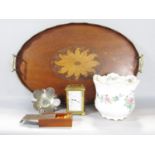 An Edwardian mahogany oval tray with a central floral inlaid medallion and brass handles, 60cm x