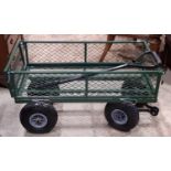 A small useful green painted metal four wheeled handcart