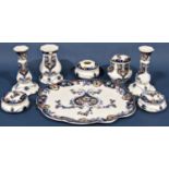 A Losel ware dressing table set comprising a pair of candlesticks, lidded pots, talcum powder