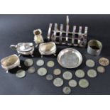 A silver toast rack, a Walker & Hall four piece condiment set, a napkin ring, a dish stamped