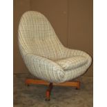 A retro Greeves & Thomas swivel egg type chair with upholstered finish raised on X framed supports