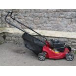 A Mountfield RS100 petrol driven rotary lawn mower and grass collection bag