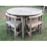 A Jonelle weathered Burma teak circular garden table with slatted top, approximately one metre in