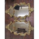 A pair of 19th century Italian mirrors, the flamboyant frames with carved detail showing floral