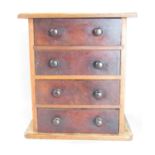 A small mahogany four drawer chest, containing a few handkerchiefs, 32cm h x 28.5cm w.