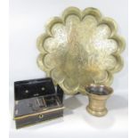 An Indian brass flower shaped tray with three figures to the centre, a brass antique mortar and a