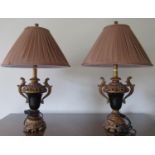 A pair of contemporary table lamps the bodies of urn shape with gilded detail and black porcelain