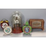 Three vintage alarm clocks, an Ingersoll mantle clock, art deco, in figured walnut case and a
