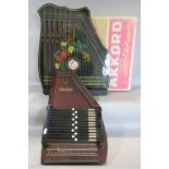 A boxed Akkord musical instrument together with an auto harp