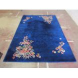 A Chinese wool carpet with pale blue ground in alternating running borders and floral detail, 360