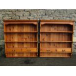 A pair of contemporary stained pine wall mounted kitchen open plate racks with graduated shelves,