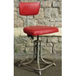 A vintage industrial swivel height adjustable office/typists chair with red vinyl upholstered seat
