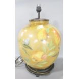 A Jenny Worral RHS china table lamp decorated with fruits on a mustard background, raised on a woode