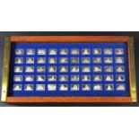 A Franklin Mint collection of Ships Of The World ingots, 50 - each 3 grams, housed in an oak box