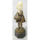 A small bronze and marble statue of a little girl holding a basket, raised on a hexagonal marble