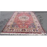 A large Persian Country House Carpet, with a central floral medallion on a field of mystical