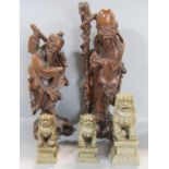 Two Chinese hardwood carved figures of wise old men together with three stone effect dogs of Fo (5)