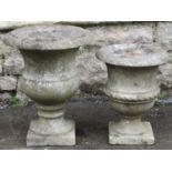 A small weathered marble urn with flared rim and square cut platform base 30 cm diameter x 38 cm