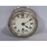 A marine or bulk head clock in a plated case work with eight day time piece
