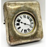 A silver mounted travelling watch case holding a silver plated cased watch with enamelled dial,