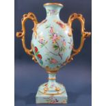 A Victorian oviform vase in turquoise with panelled detail showing butterflies, moths, floral