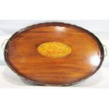 A large oval Edwardian mahogany tray with central inlaid oak leaves and acorns with two brass