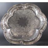 A Victorian silver tray, heavily engraved, raised on three supports, maker Elkington, Birmingham