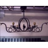 An unusual ironwork hanging ceiling light, the looped X frame in the form of two longboats