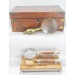 A 19th century burr walnut writing box, a desk top letter opener and magnifying glass on a stand,