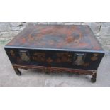 A Chinese black lacquered box on stand with chinoiserie detail and brass fittings, the stand with