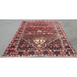 A middle eastern design carpet with a central vase of flowers and floral borders, 280cm x 208cm
