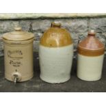 Two vintage stoneware flagons, one and two gallon capacity both with impressed merchants marks for
