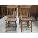 A set of four turned spindle back kitchen dining chairs principally in ash raised on turned supports