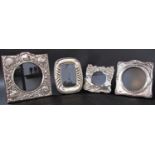 Three silver photo frames with circular openings, various designs, and a single photo frame with