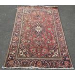 A Tabriz type carpet with an all over floral pattern on a pink and blue ground, 186cm x 125cm approx